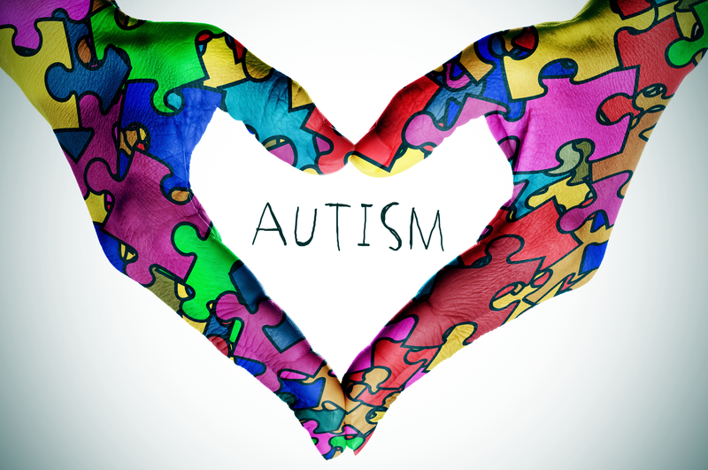Autism with puzzle rainbow hands