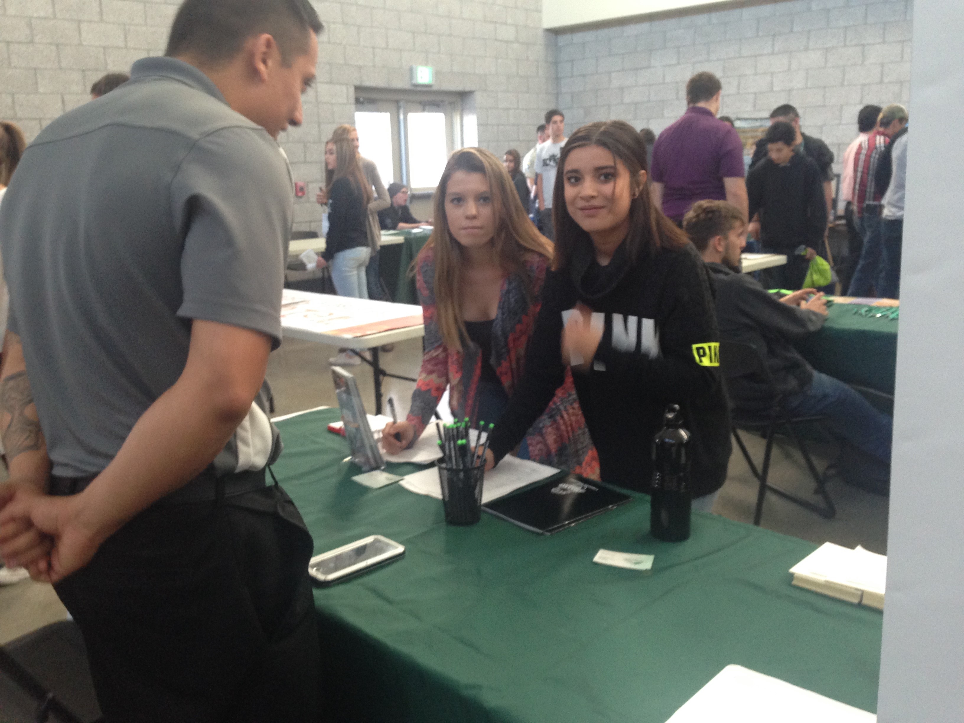 photo of students talking to teacher