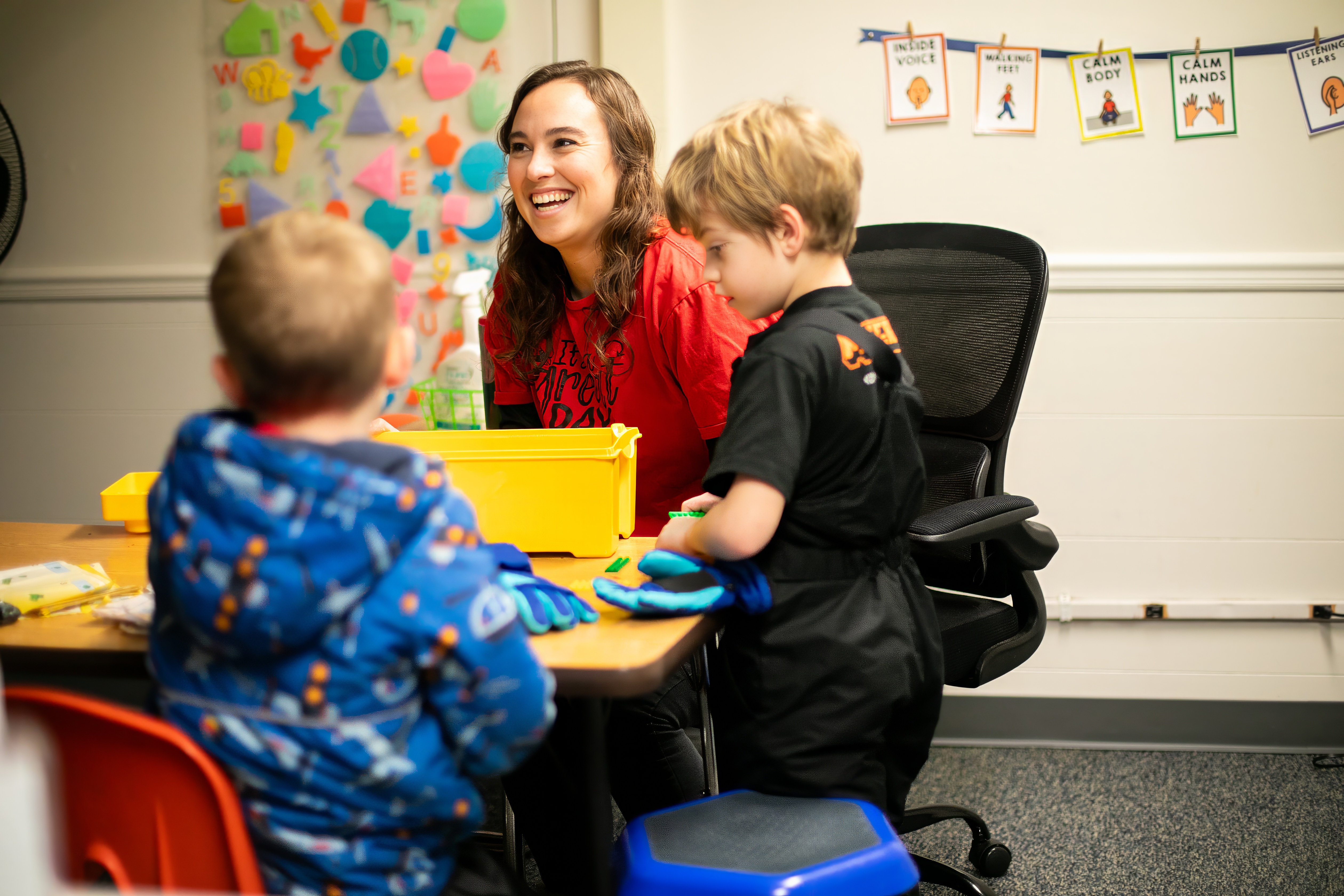 teacher laughing with students 