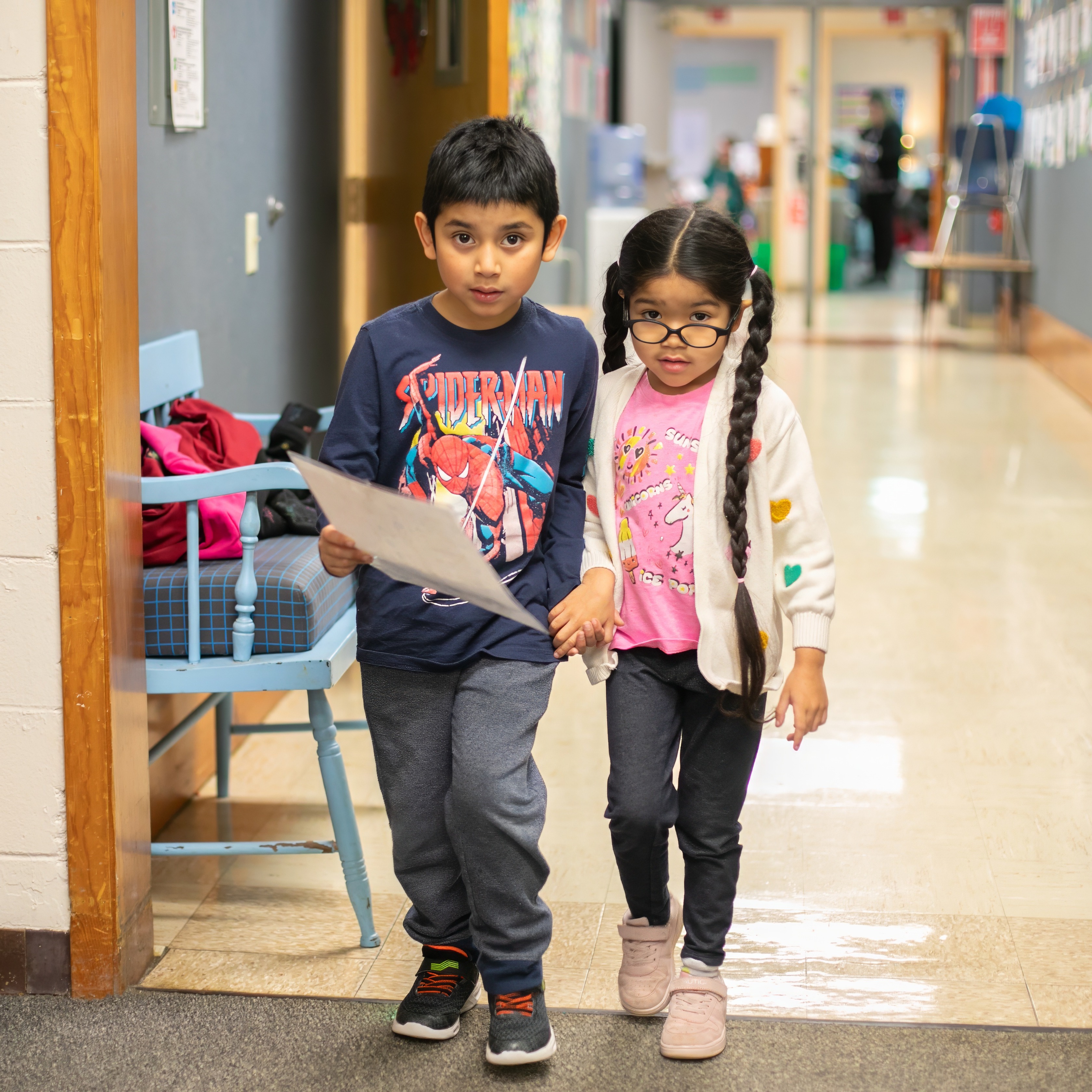 two walking down the hall holding hands