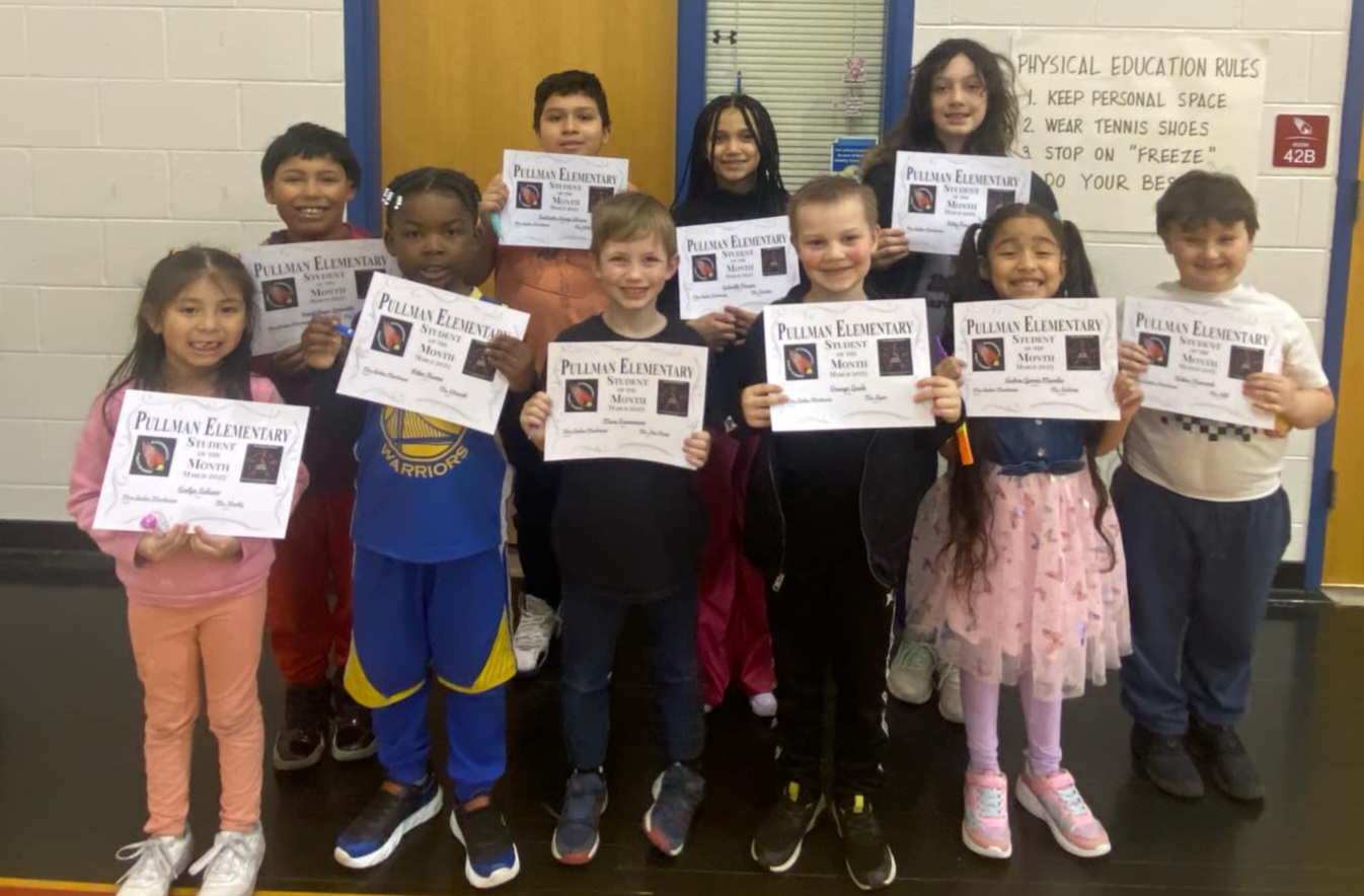 The 10 students of the month for March, each holding their certificates