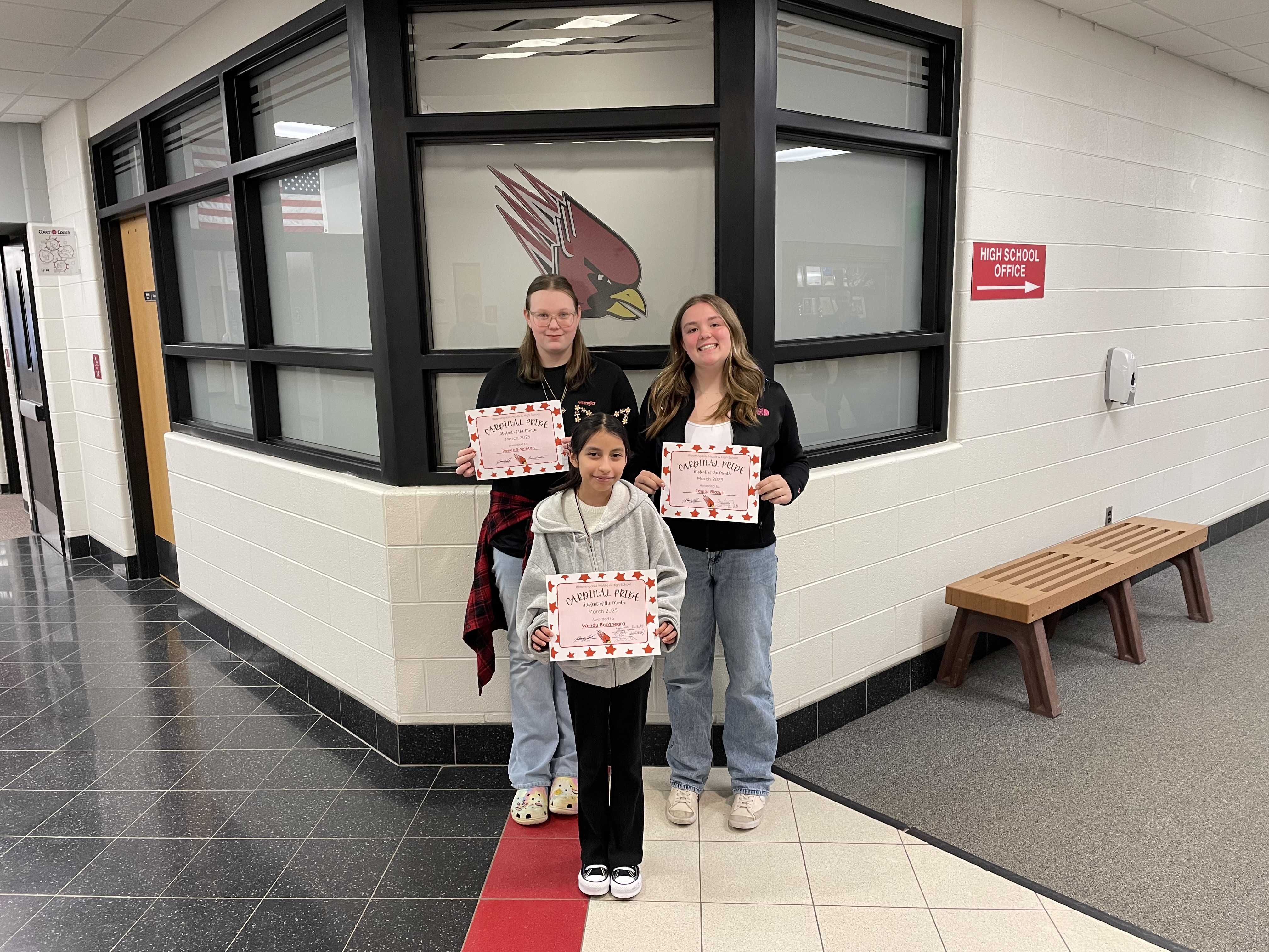 3 students of the month with their certificates