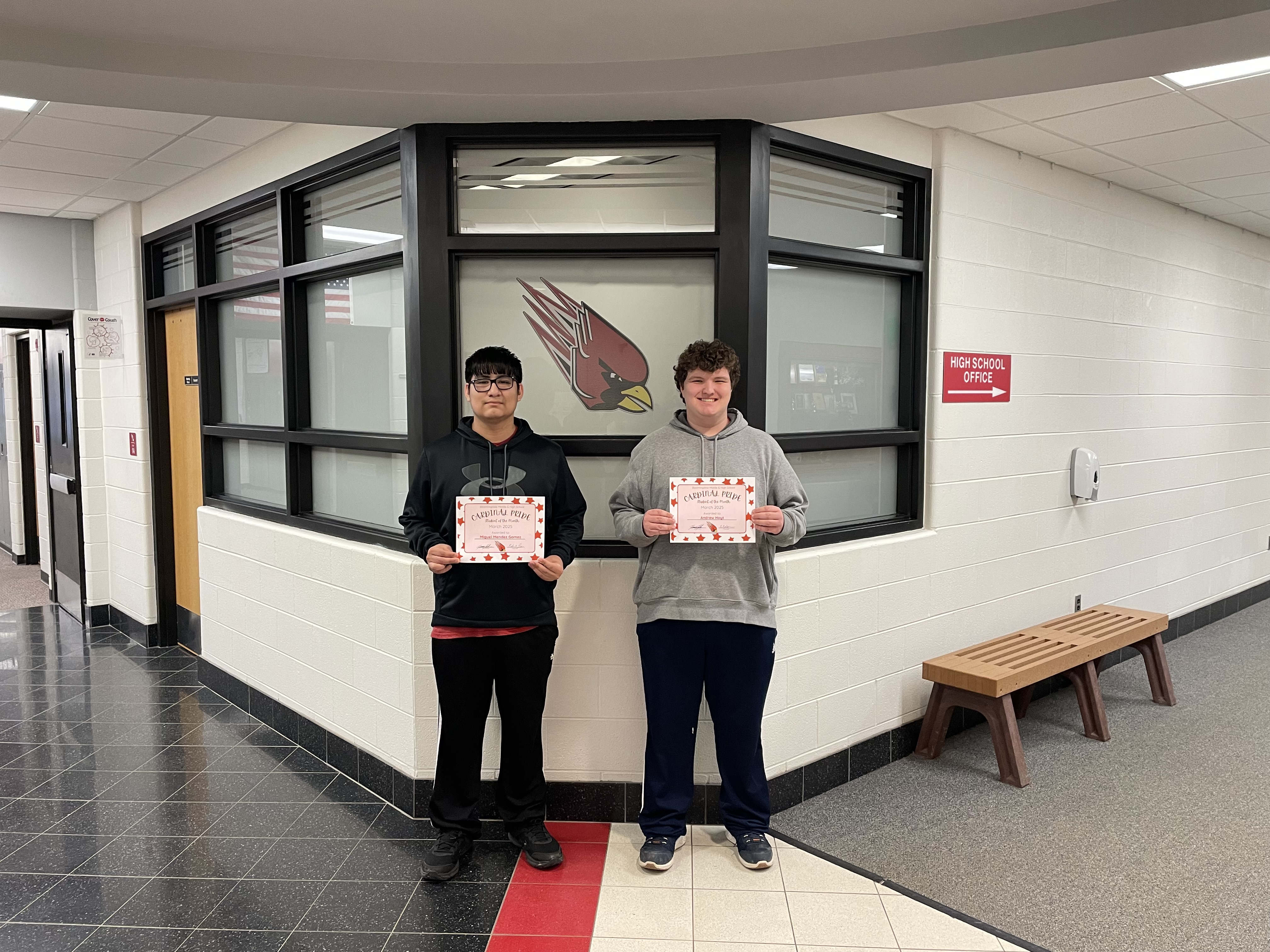 2 students of the month with their certificates
