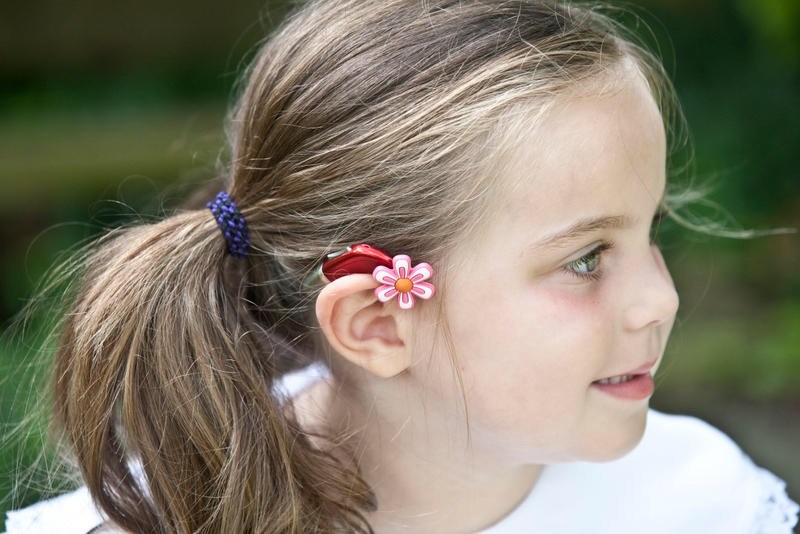 Young girl with hearing device