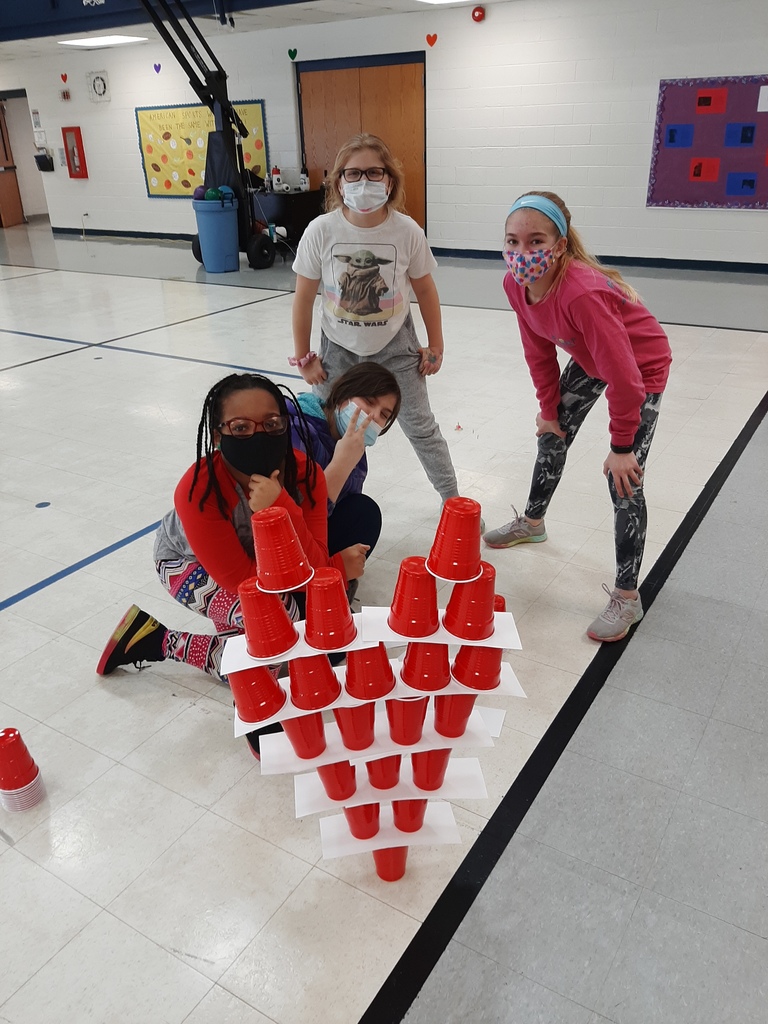 Students building cup tower