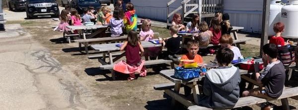 K-2 grades enjoying lunch outside in the beautiful sunshine!