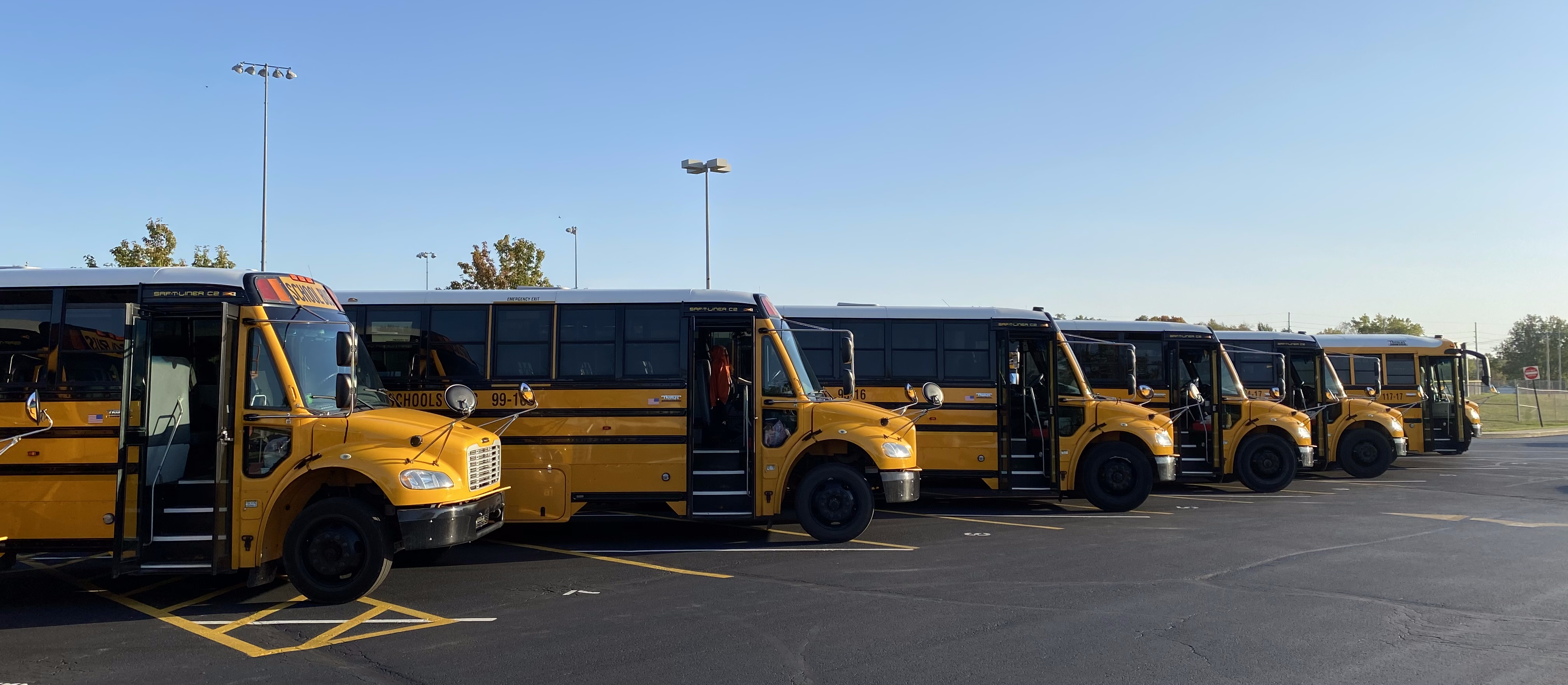 Buses lined up in a parking lot