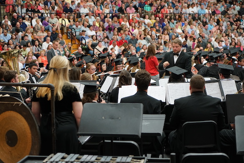 Band students preparing to play for a packed stadium