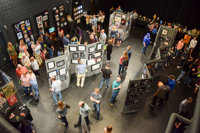 aerial view as guests view pieces on display at the art show
