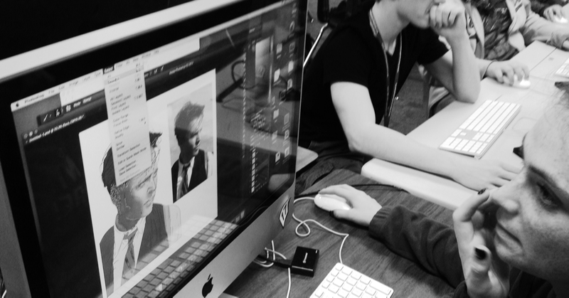 grayscale photo of student working in adobe photoshop on computer screen