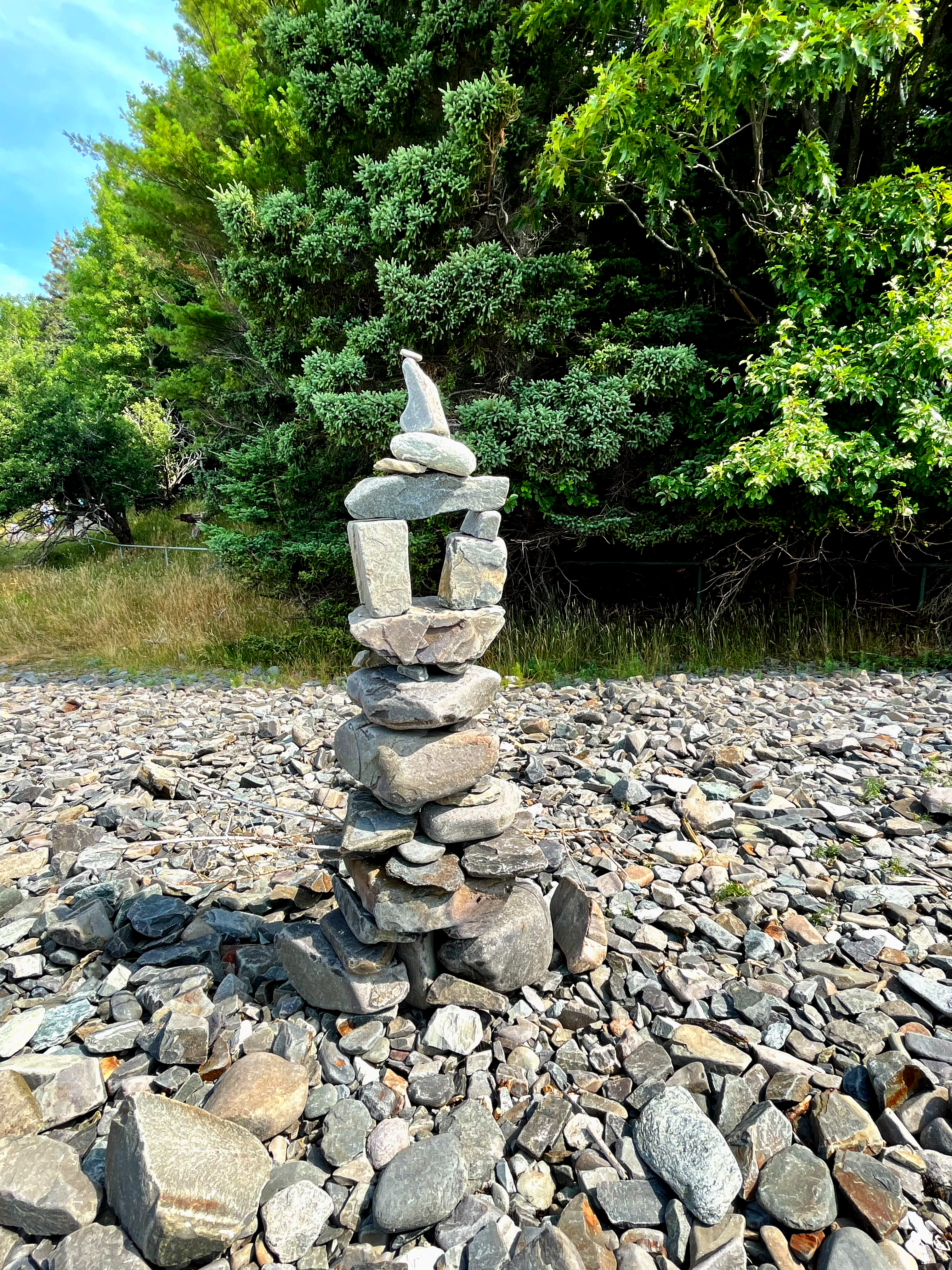 photo of rocks being stacked in a creek bed