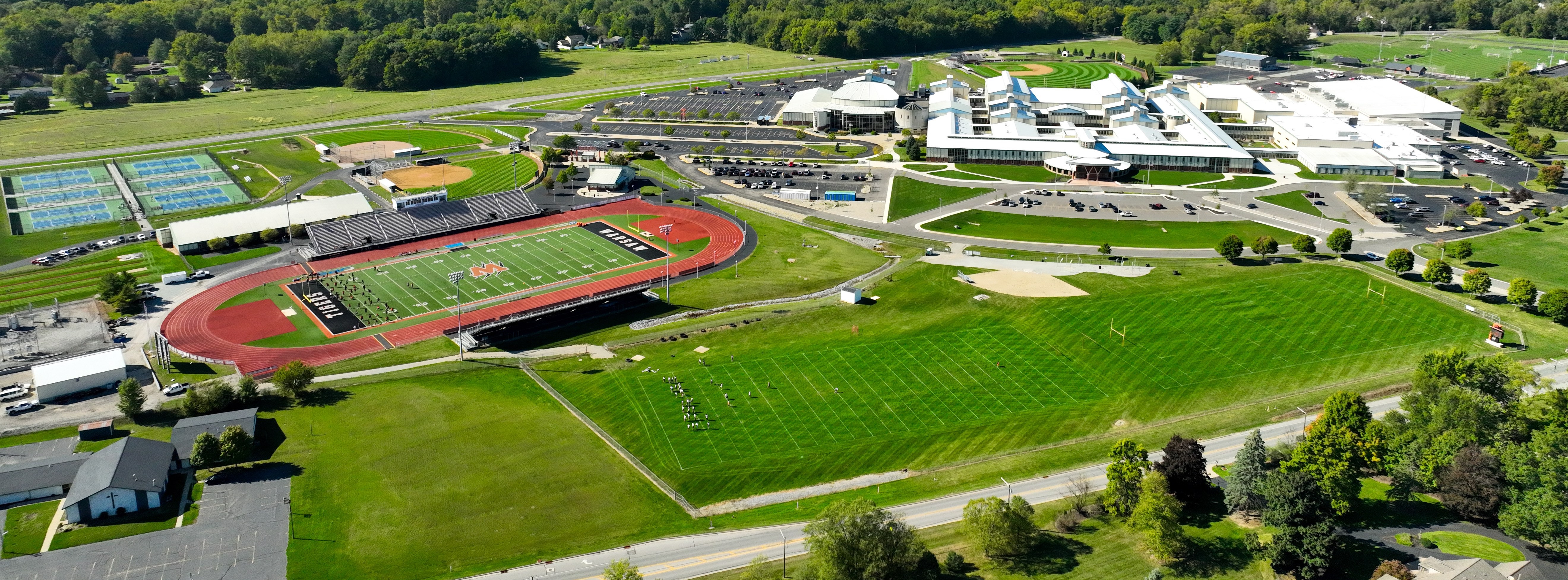 aerial view of high school campus and football field