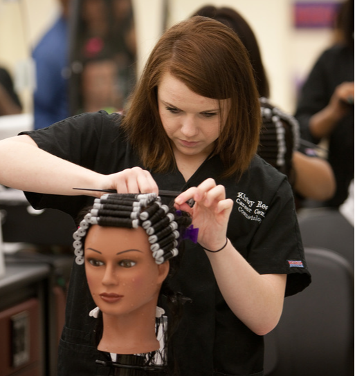 student practicing styling on a mannequin