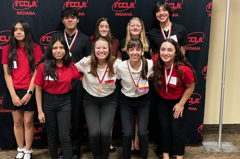FCCLA students pose with medals in their uniform