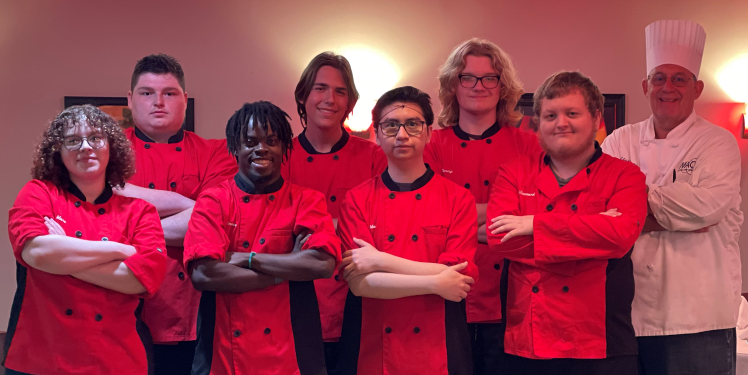 ADVANCED CULINARY ARTS students pose at the entrance to the blue apron