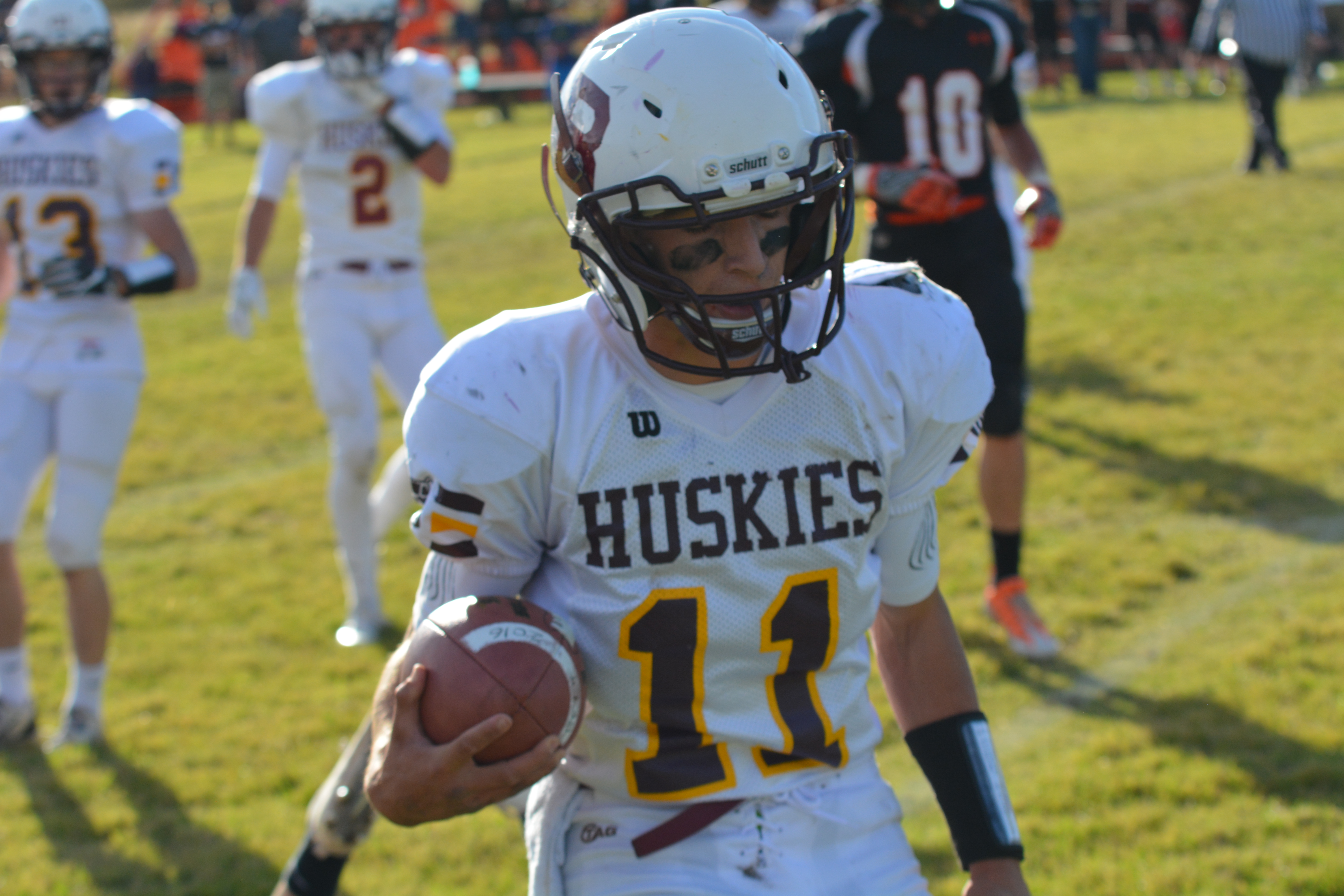 A student wearing the emblematic football uniform of the school's district.