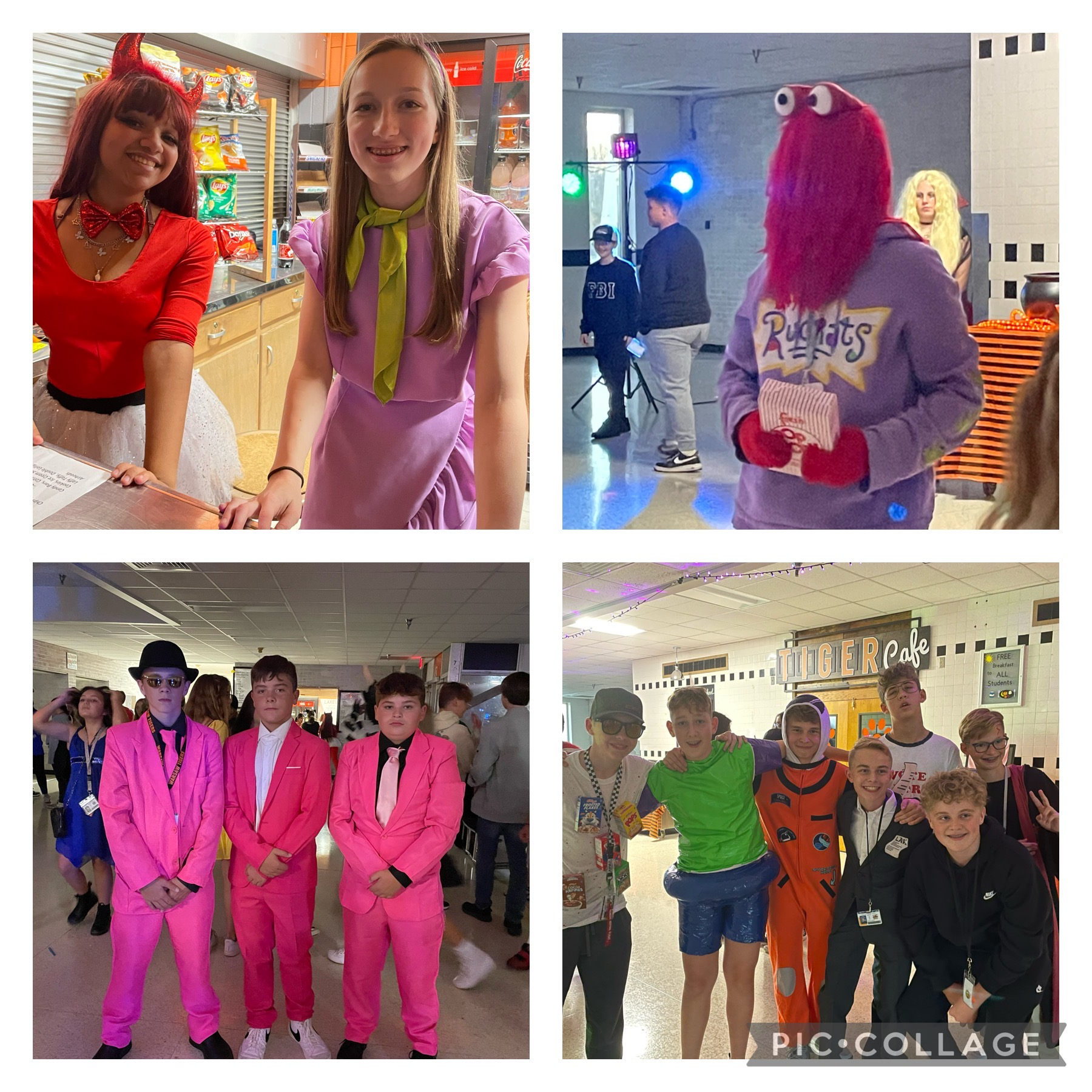 Students posing in their halloween costumes; velma and daphne from scooby doo, a red elmo monster, three young men in bright pink suits, and a group of students surrounding an astronaut