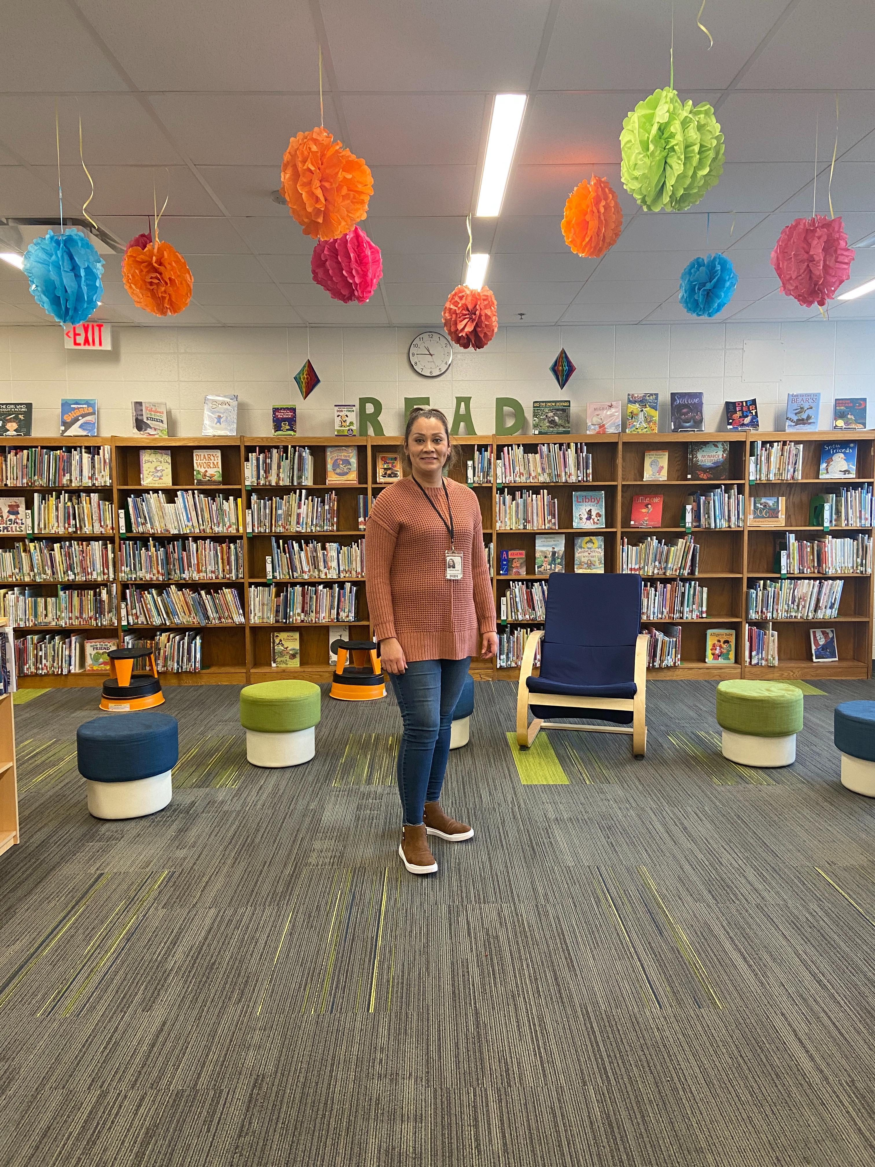 Mrs. Fabiola Nuñez, the Digital Learning Specialist, standing in the library