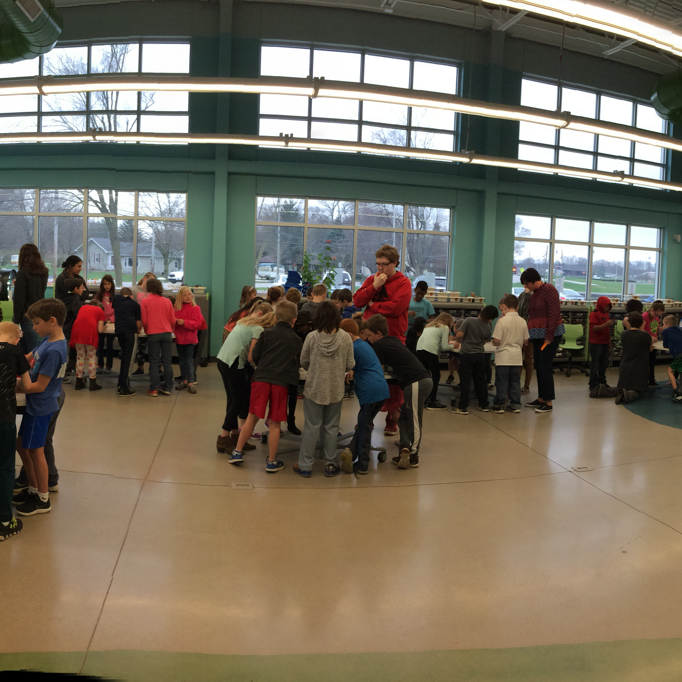 Large group of students at multiple tables