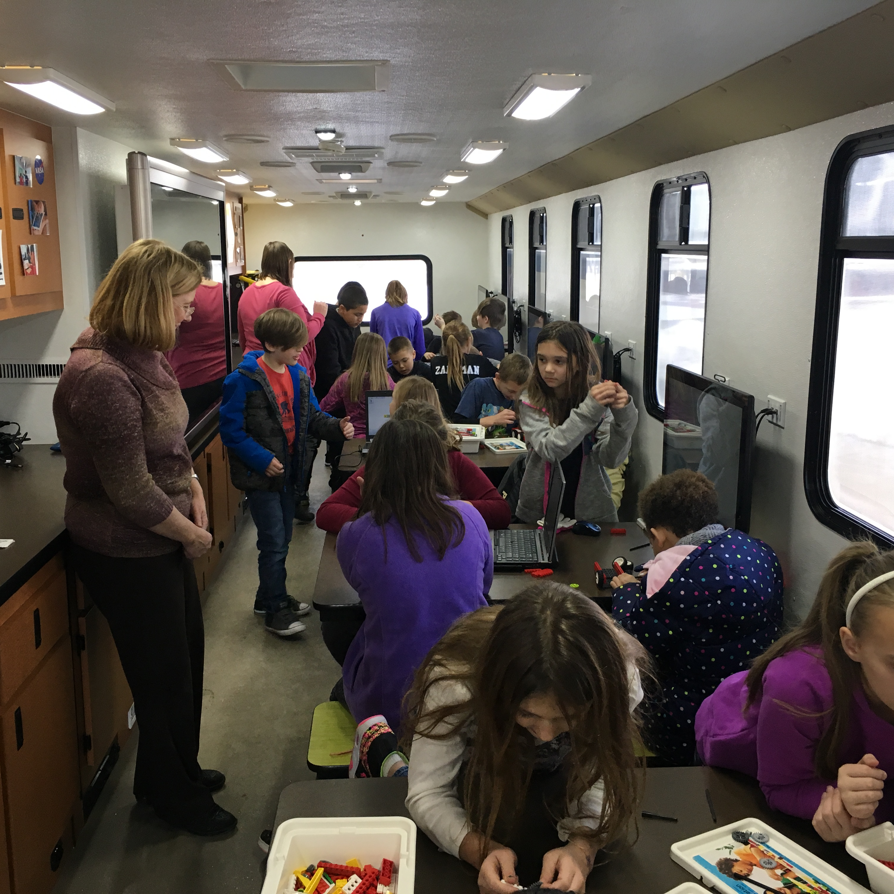 Students doing crafts and using computers