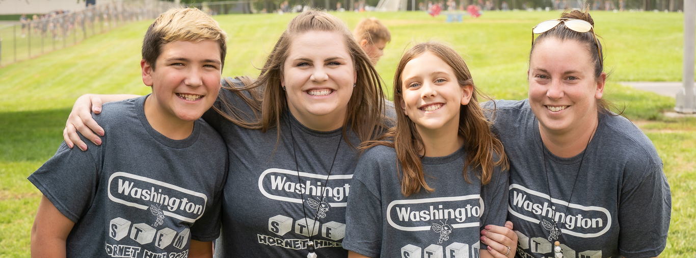 Students and teachers smiling for the camera