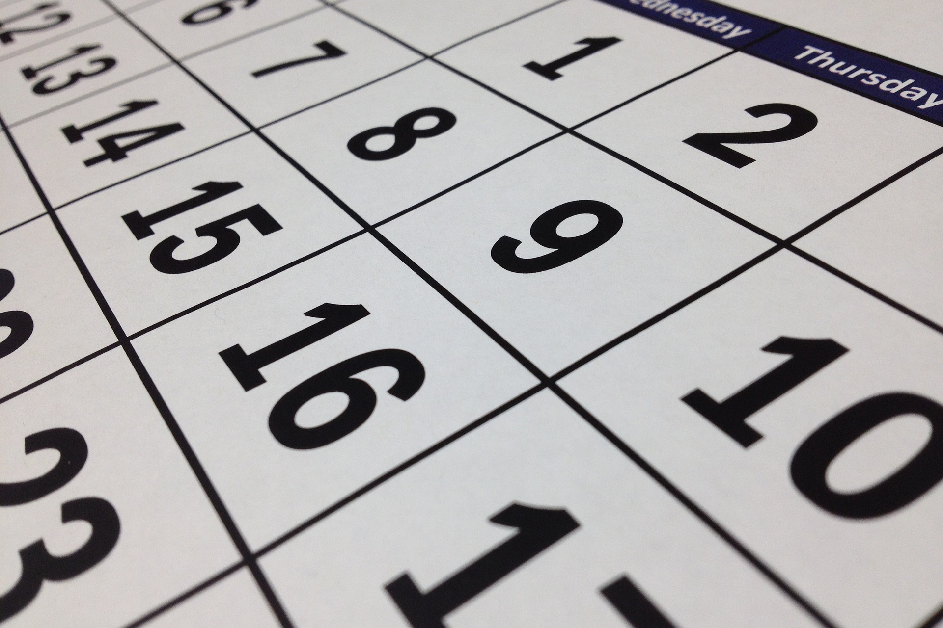 A close up image of a paper monthly calendar at an angle.