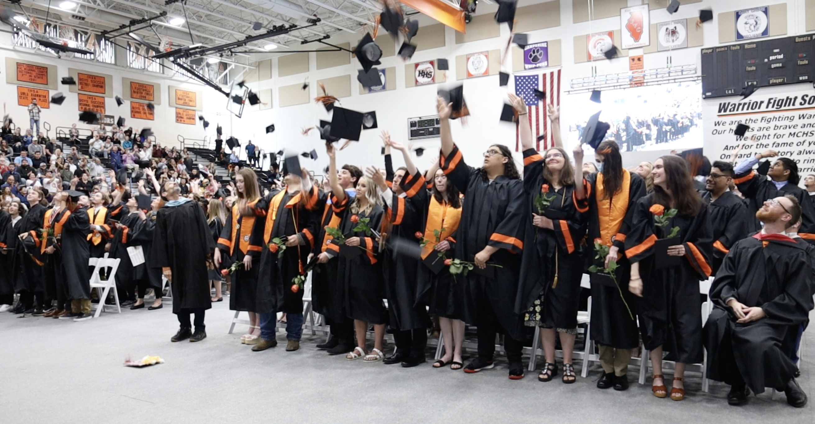 Seniors throwing graduation hats