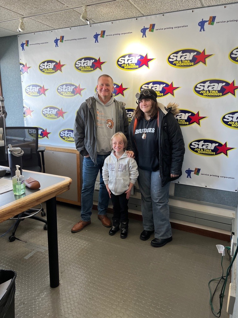 Bridges clients and instructor in front of STAR 105.5 background