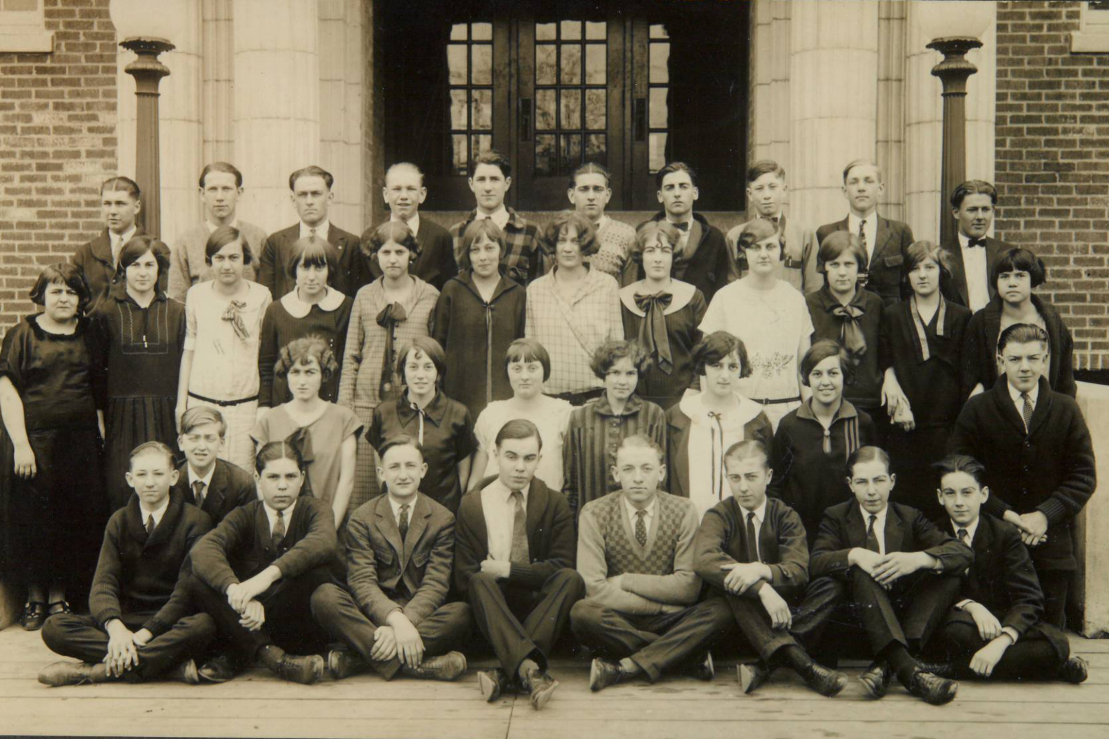 Old black and white photo of a class in front of East Campus