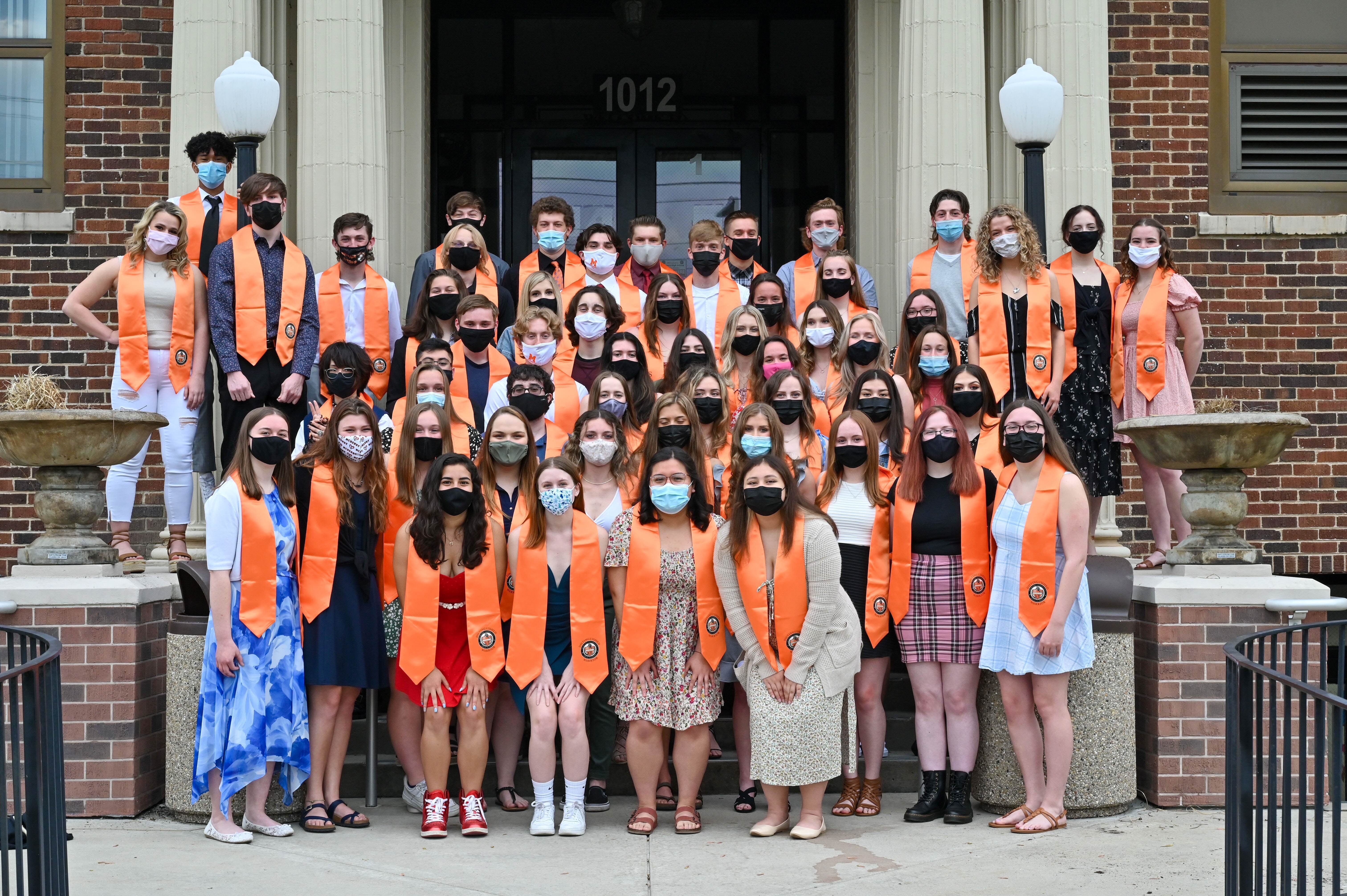 East Campus Distinguished Warriors 2021 in stoles in front of East Campus wearing masks Class of 2021