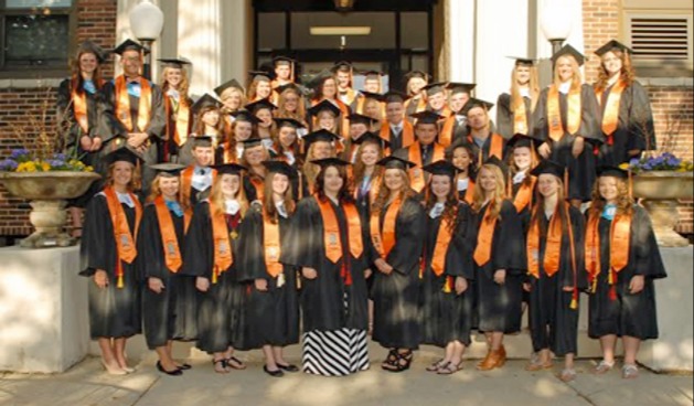 Class of 2015 East Campus Distinguished Warriors in stoles on graduation day in front of East Campus