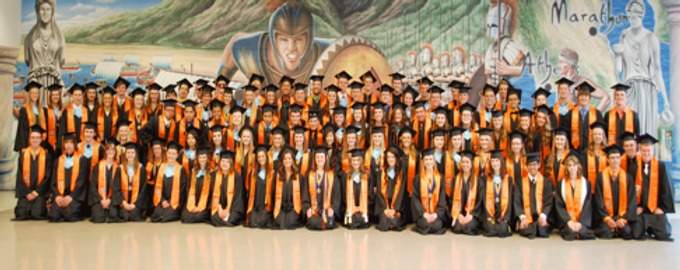 Distinguished Warriors in stoles Class of 2014 in front of Warrior painted wall