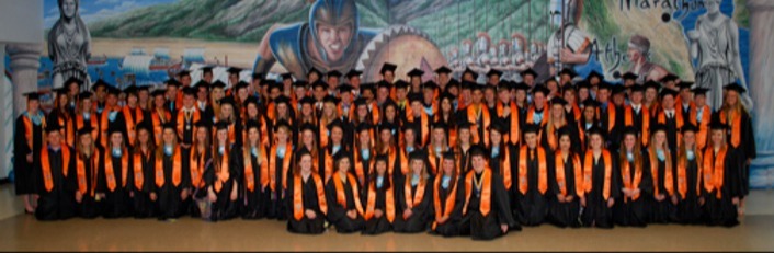 Distinguished Warriors in stoles in front of Warrior Wall  in graduation caps and gowns Class of 2013