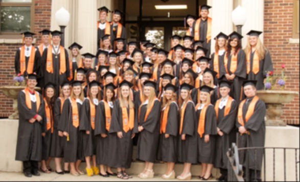 East Campus Class of 2013 Distinguished Warriors in stoles at graduation in front of East Campus