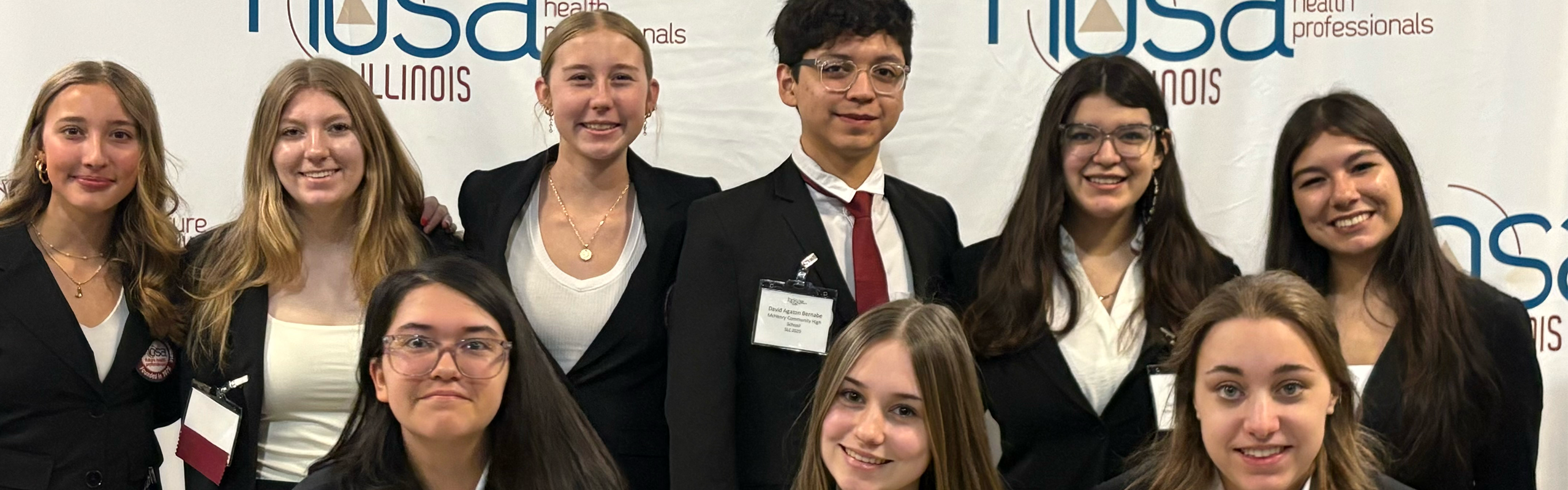 Nine students in front of HOSA Illinois Future Health Professionals 