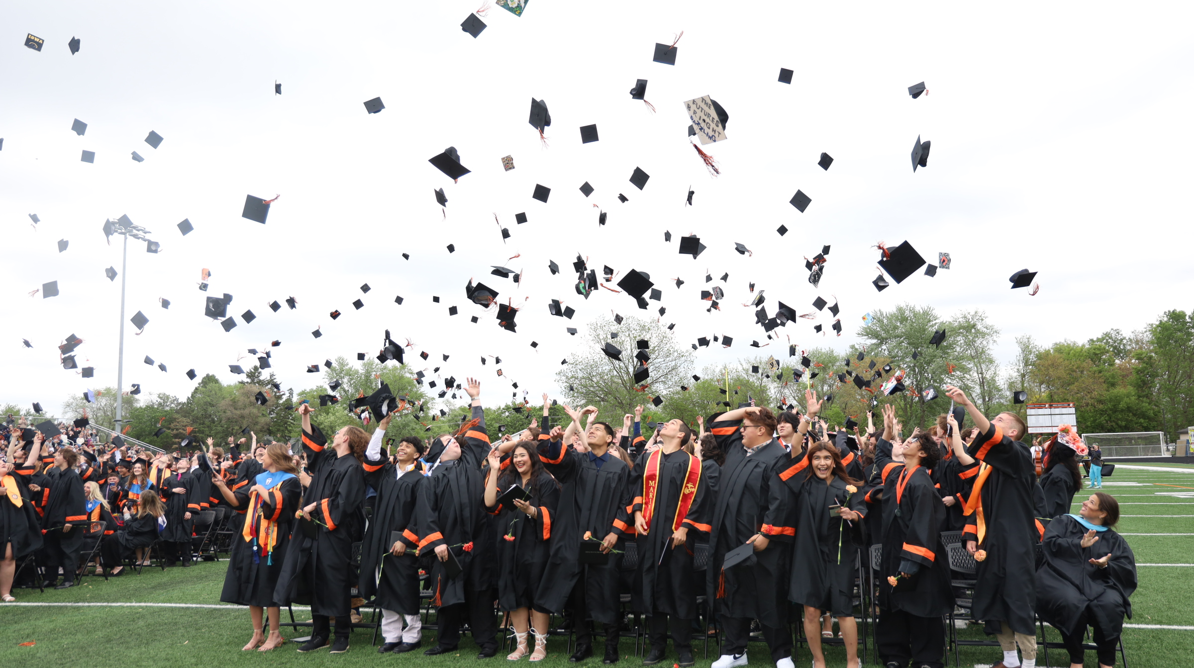 Graduation caps in the air