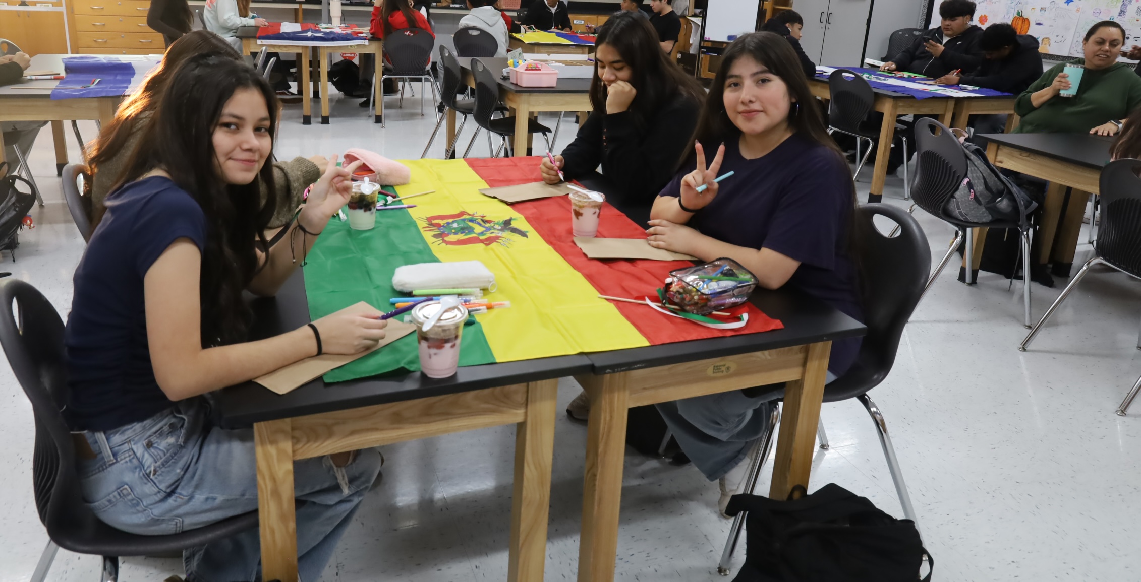 Students with a country's flag and drawing