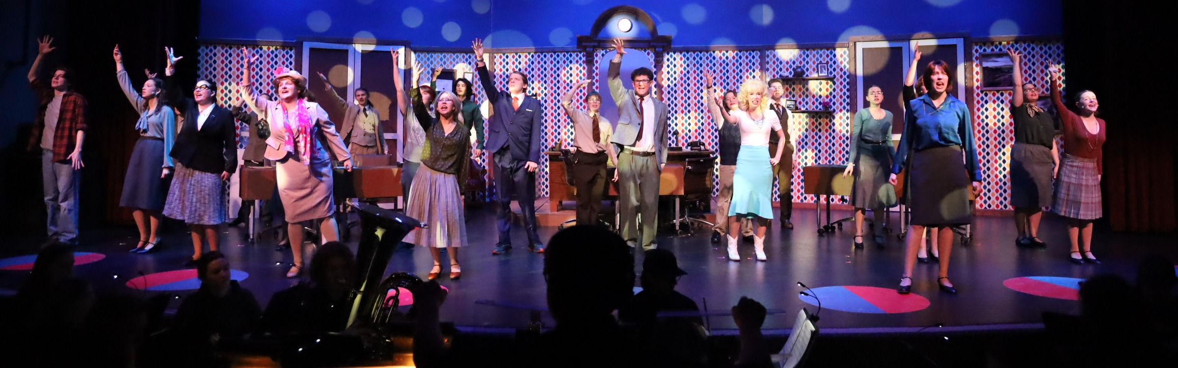 Cast of a musical on stage dancing