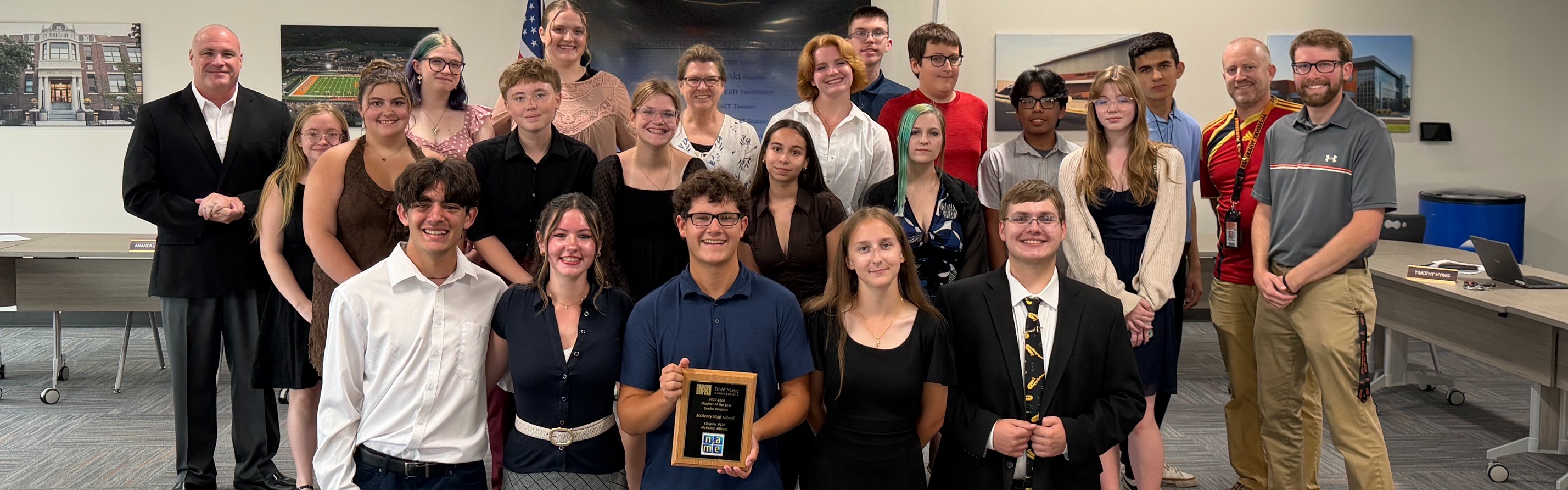 Tri-M gathered together with award with board members and admin