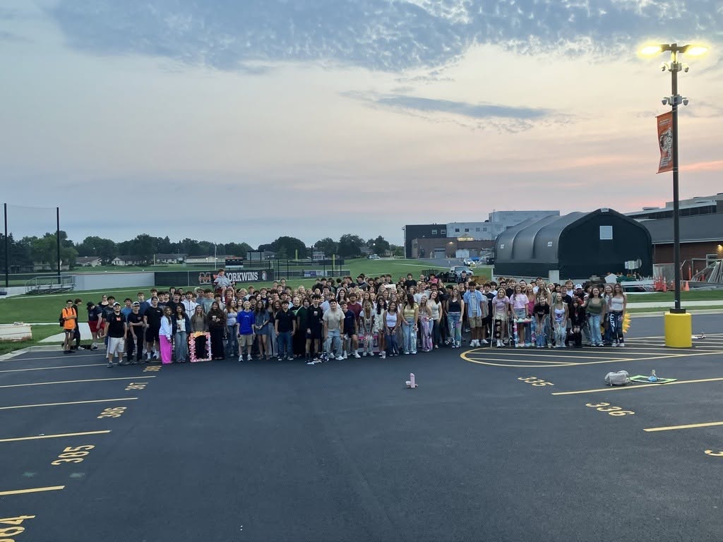 Seniros standing at senior sunrise in the parking lot