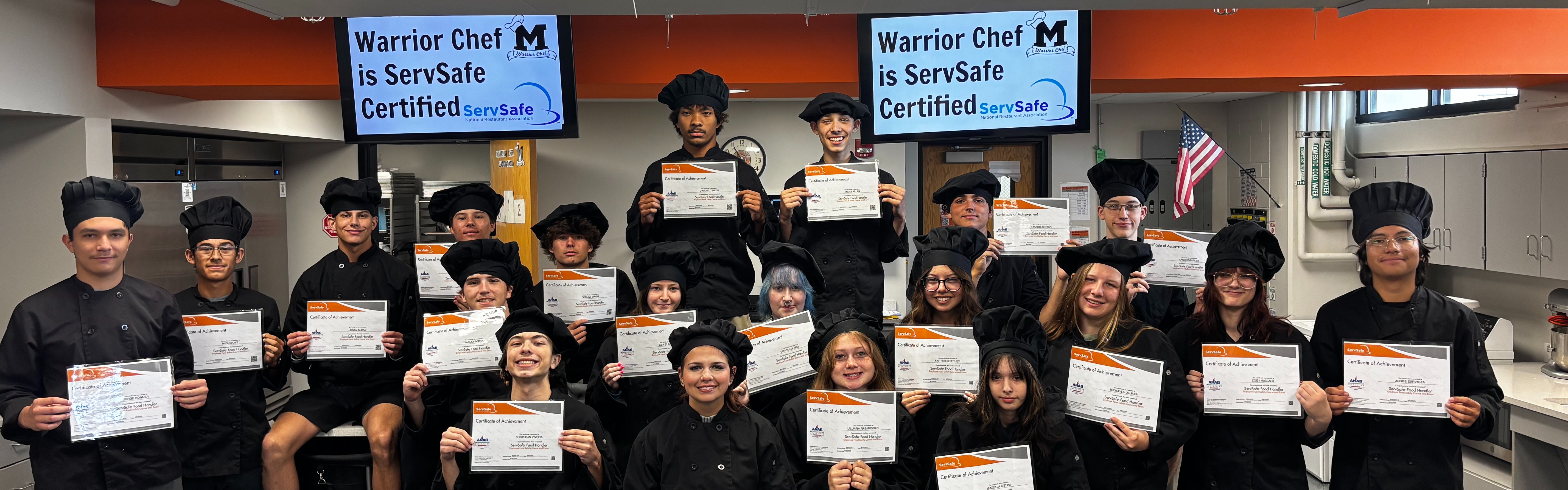 Culinary students holding cerifcates