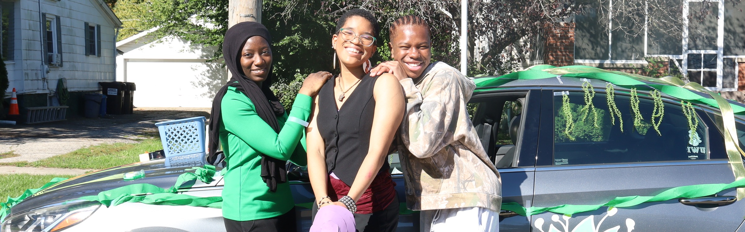 Students posing in front of float