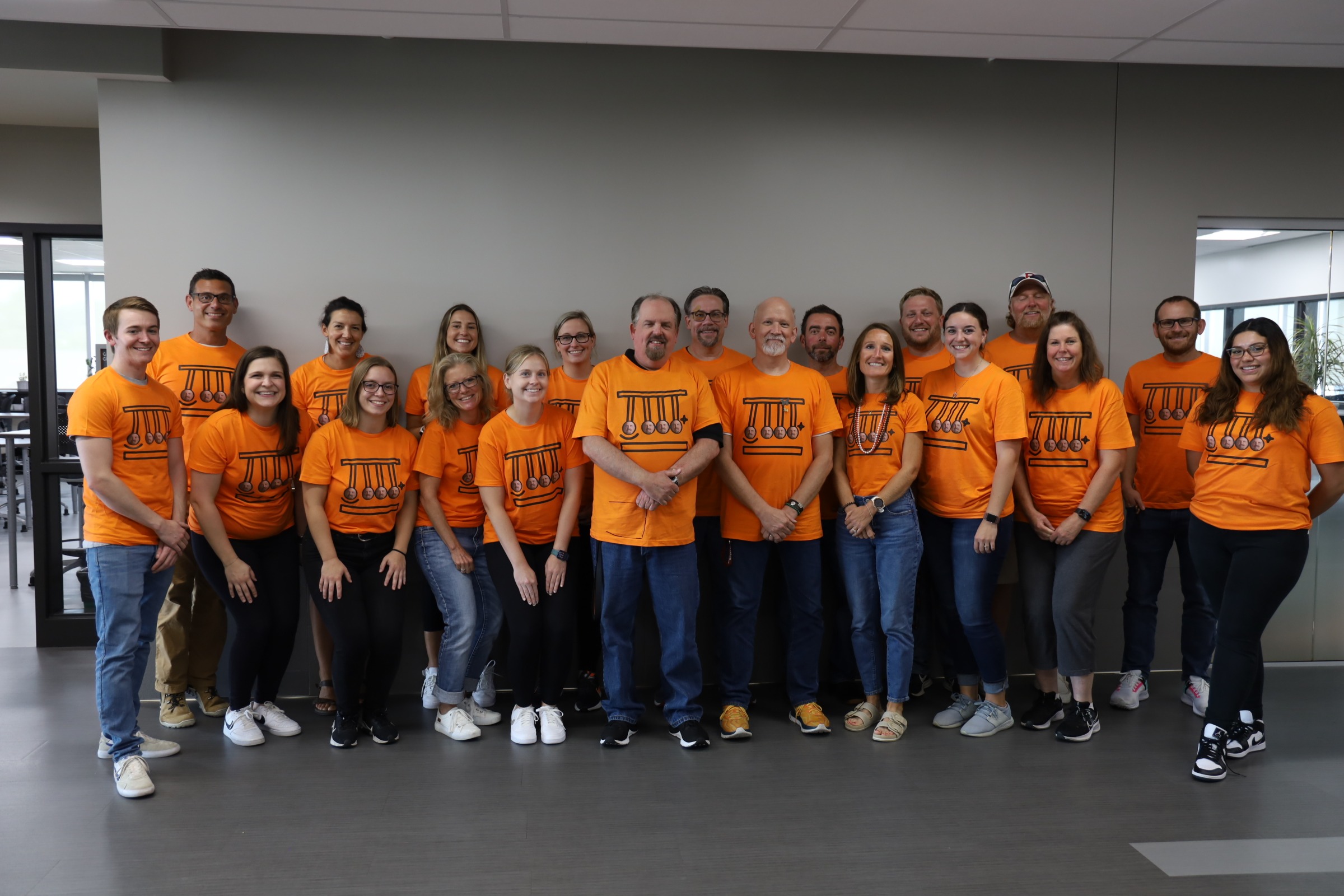 Science Department group photo in matching orange shirts 
