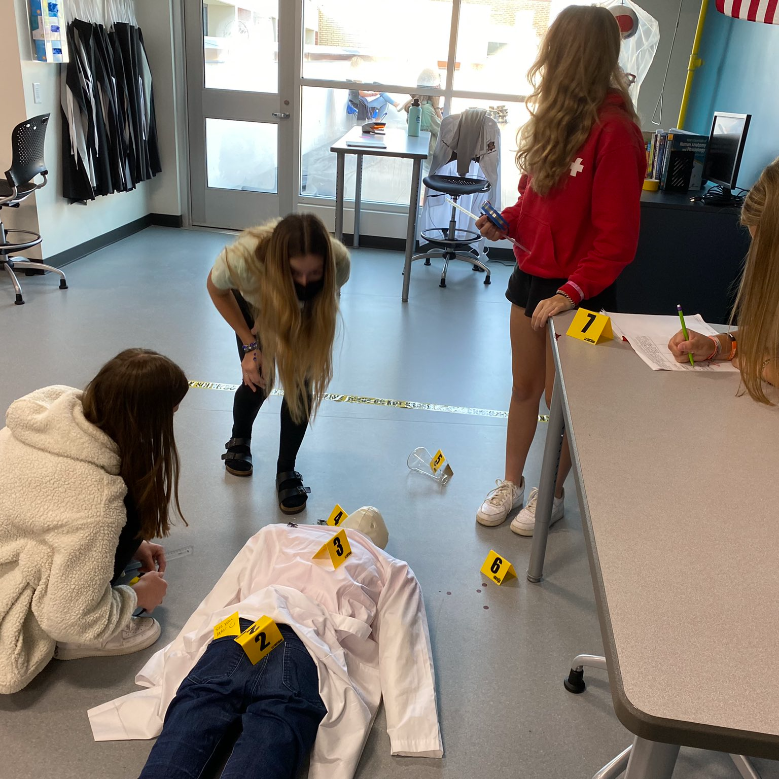 forensics looking at a mannequin body