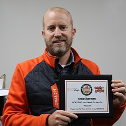 Greg Eiserman holding Staff Member of the Month Award