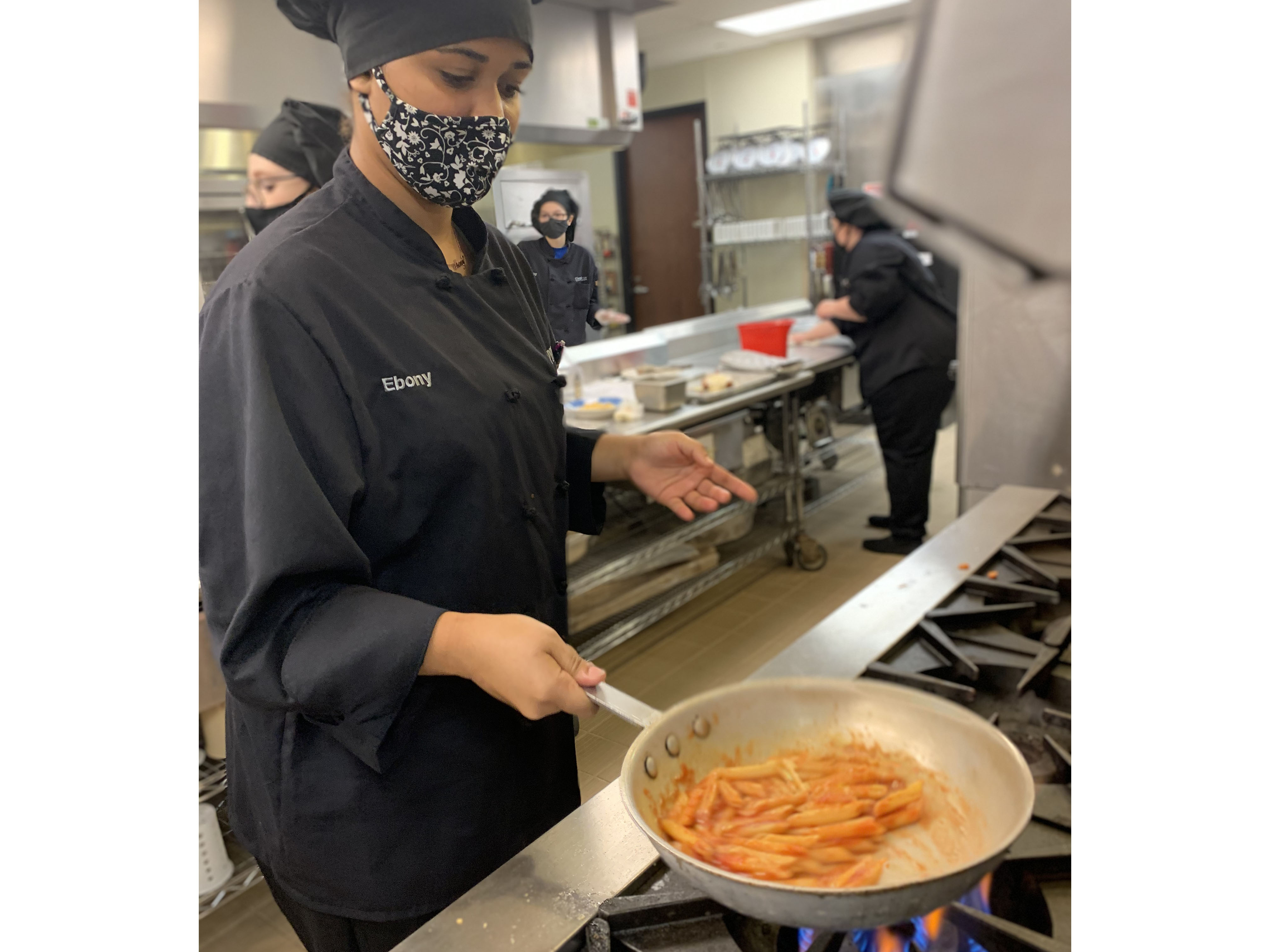 Student cooking pasta in the restaurant kitchen