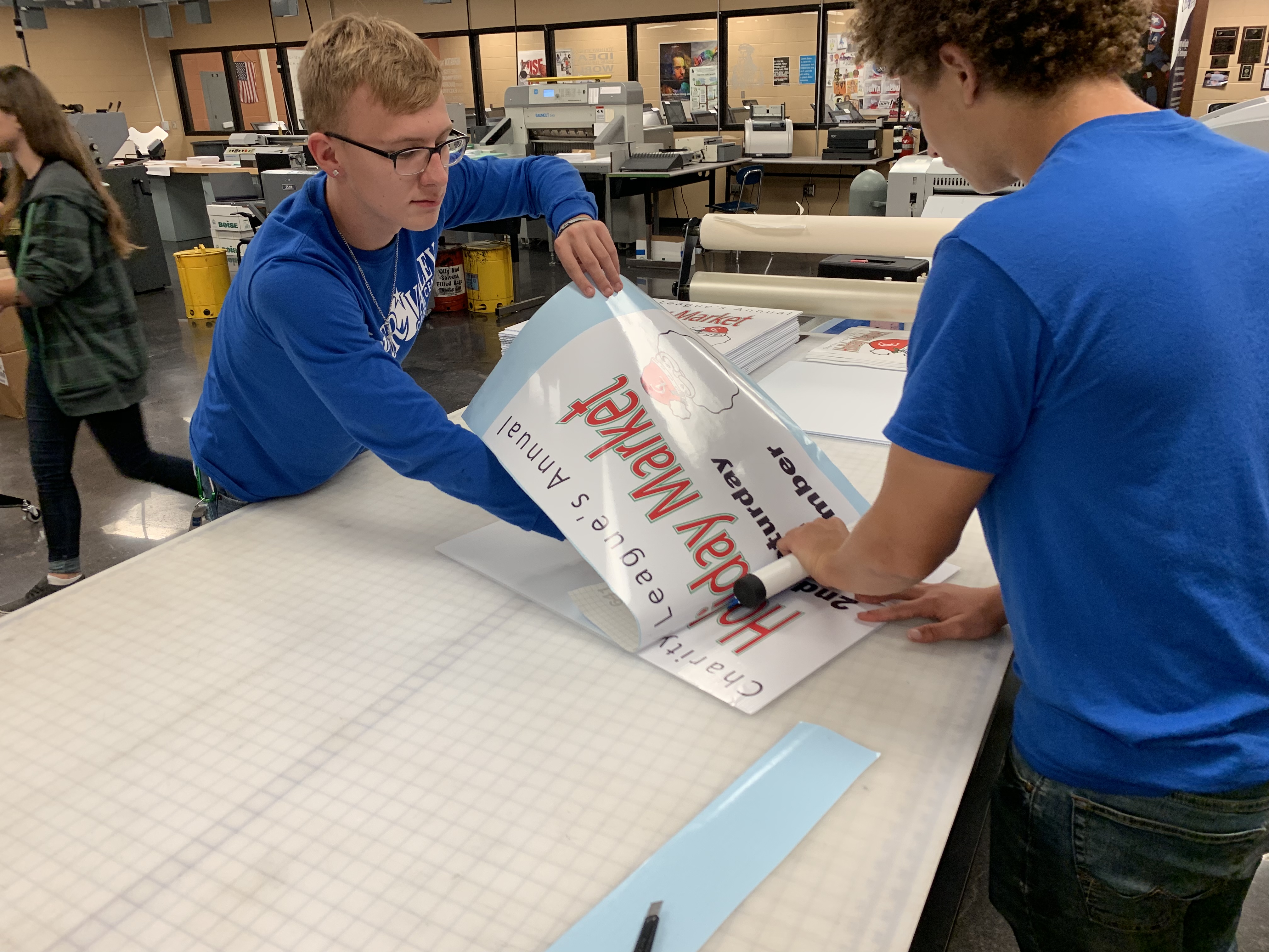 Students working on a vinyl application