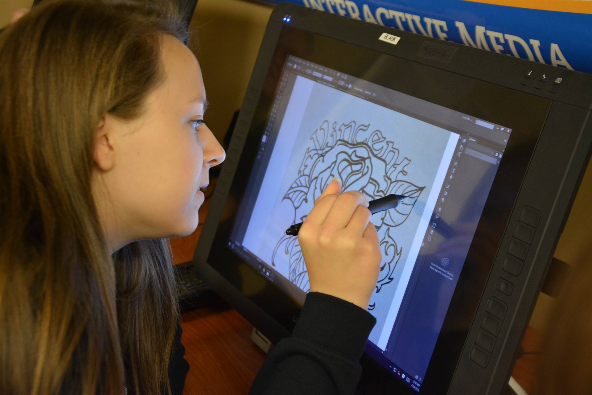 Student drawing in a tablet