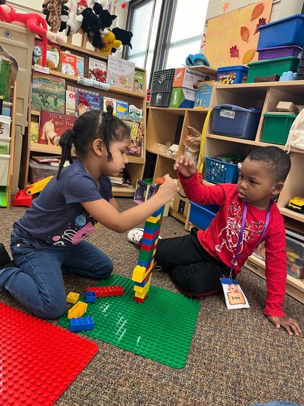 Students in preschool play with legos