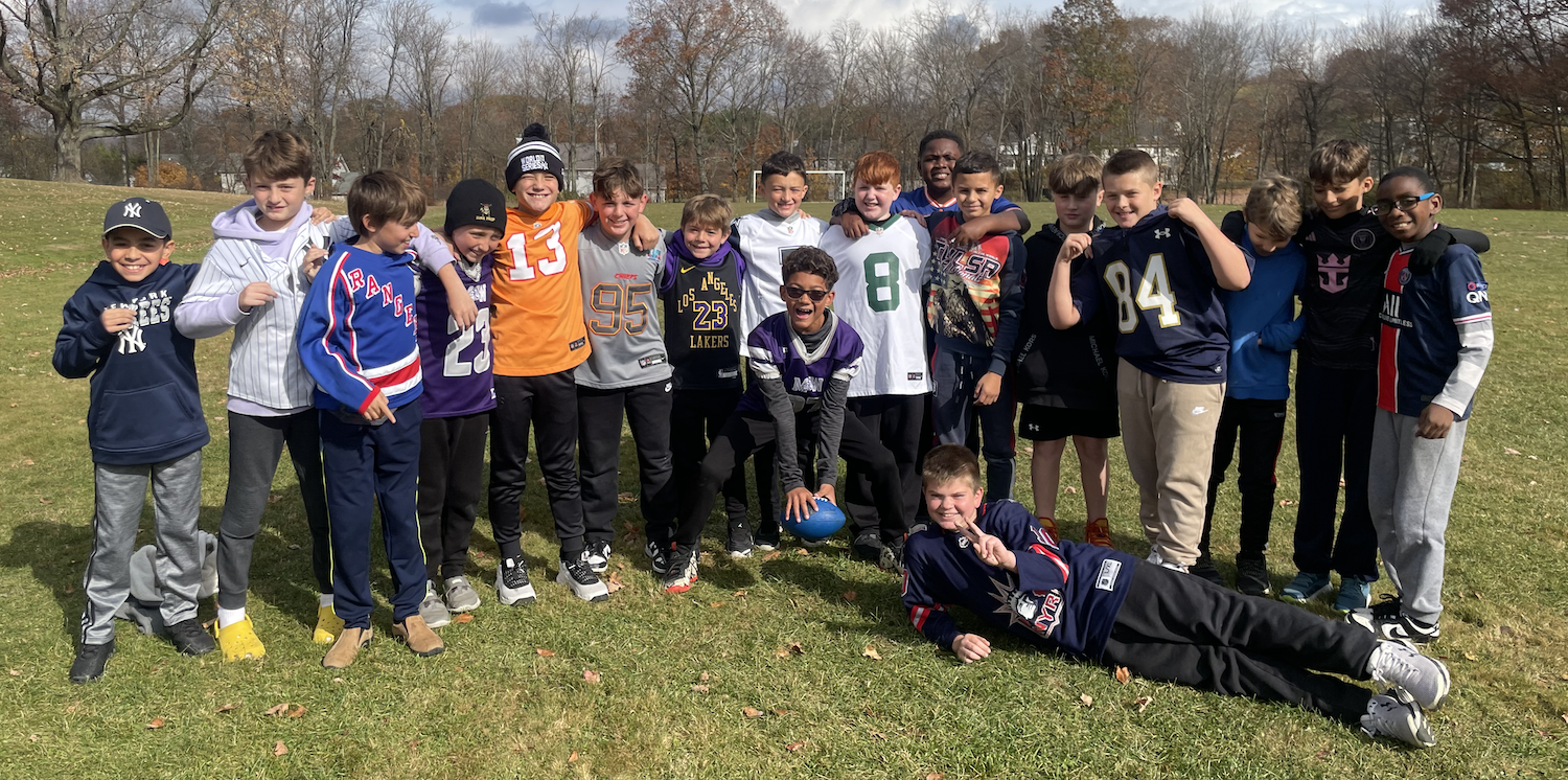 eighteen boys on a football field